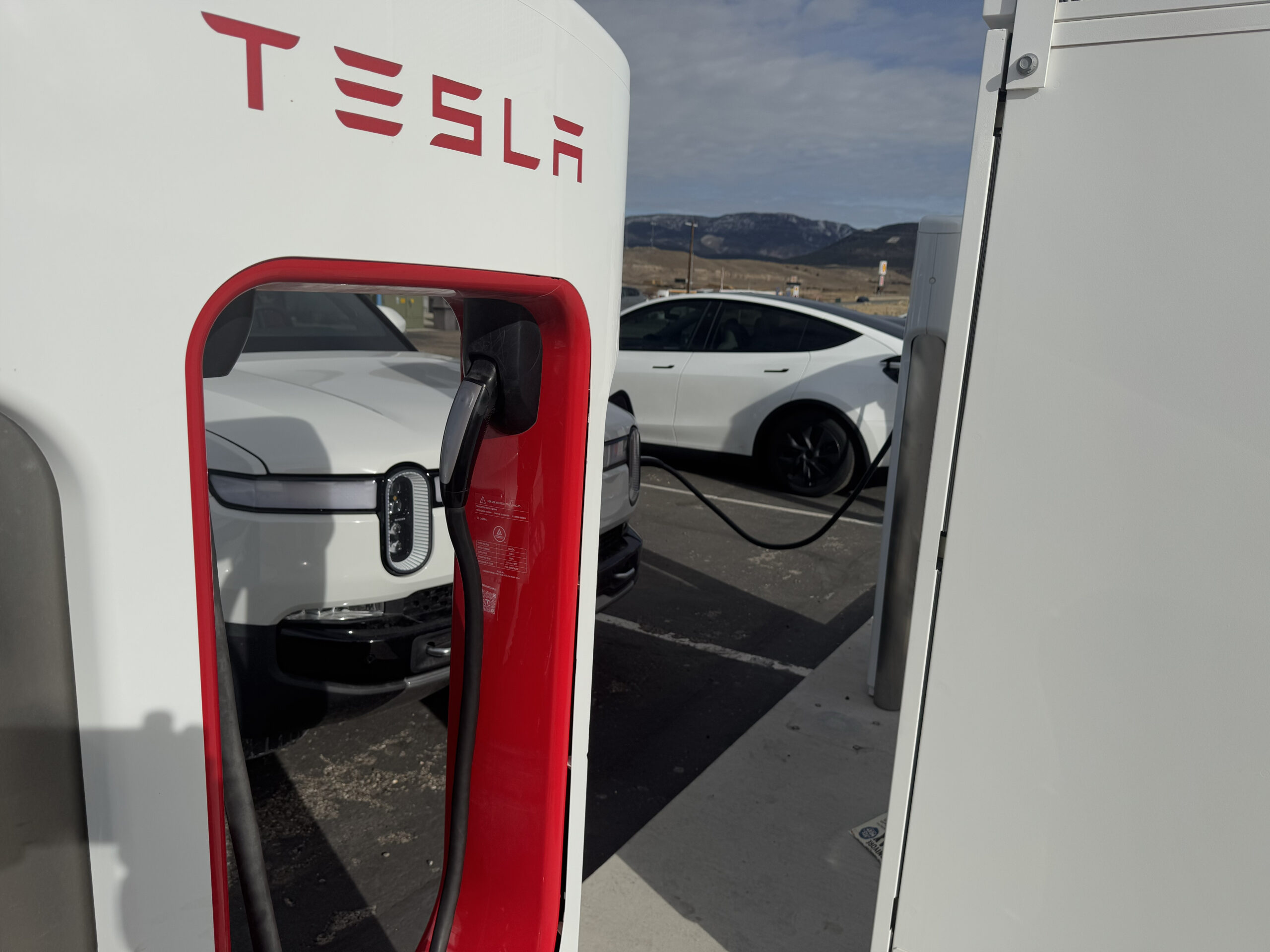 9469 Rivian SUV supercharging. Tesla NACS Supercharger. Beaver Utah. January 1 2024. Photo by Fritz Hasler scaled