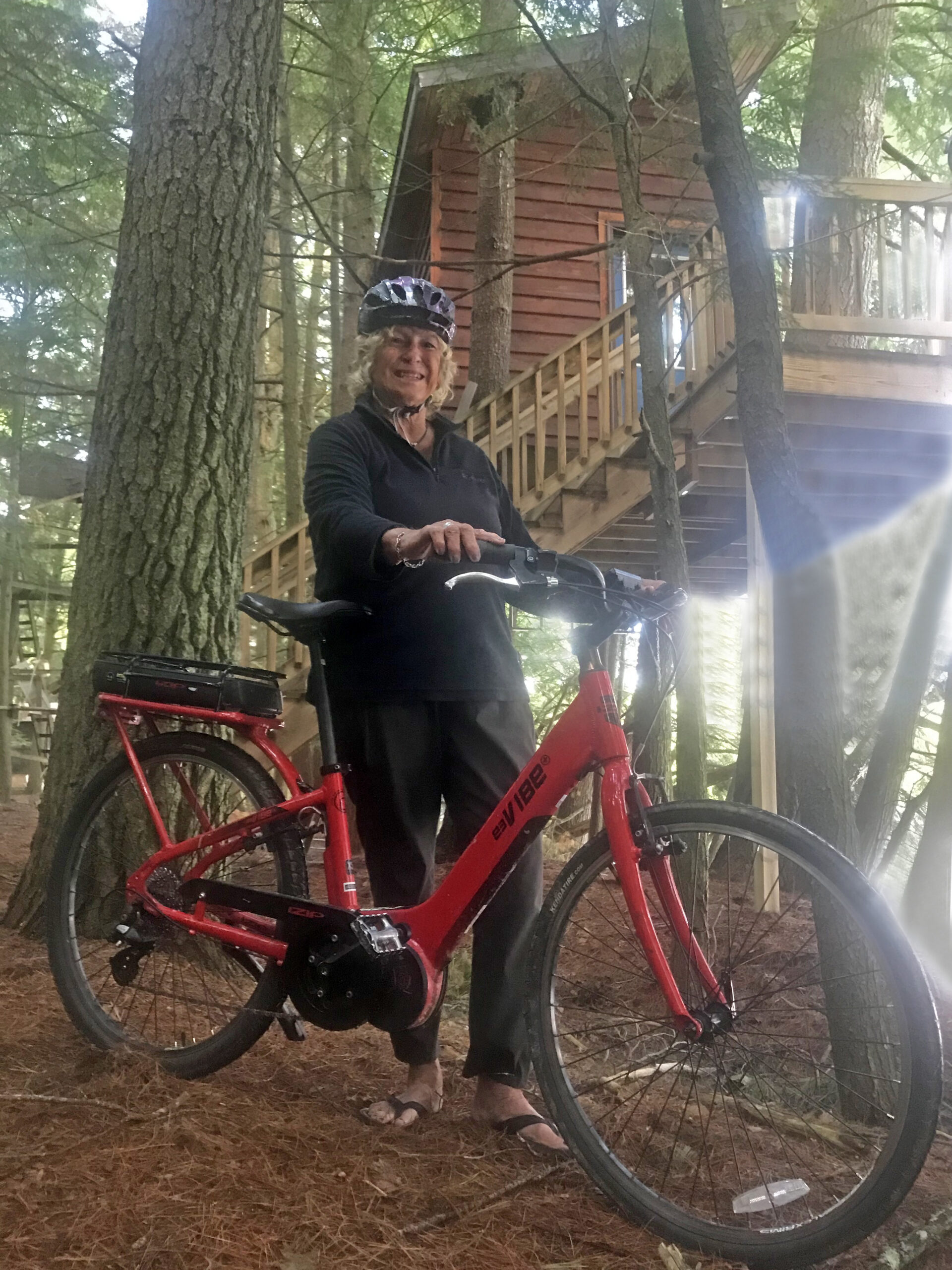 My wife with an iZip E3 Vibe mid-drive step-thru beach bike. Purchased in 2016. My treehouse, Camp Hasler, Three Lakes, Wisconsin. Fritz Hasler photo.